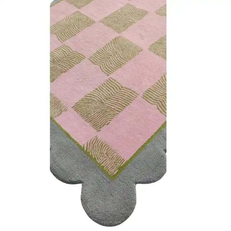 A beautifully designed area rug featuring a pastel pink and beige checkered pattern with a scalloped grey edge. This contemporary wool rug is perfect for adding a touch of elegance to any dining room or living room, making it an ideal choice for those seeking formal dining room rugs or area rugs for living room spaces.