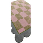 A beautifully designed area rug with a pastel harmony scalloped leaf pattern, hand tufted for a luxurious feel. The contemporary rug features a checkerboard design in soft pink and green, ideal for enhancing dining room, living room, or formal dining room décor. Made from high-quality wool, this area rug adds a touch of elegance and warmth to any space.
