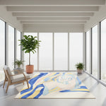 Modern room with a colorful abstract rug, chair, and potted plants.