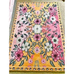 The Pastel Paradise Hand Tufted Rug showcases a vibrant floral design in shades of pink, yellow, and white, perfect for adding a touch of elegance to any living room. This vintage wool rug features intricate floral patterns, making it an ideal choice for those seeking stylish living room area rugs.