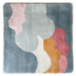 Top view of a pastel-colored hand tufted wool rug featuring abstract cloud-like shapes in blue, pink, and orange, perfect as an area rug for a living room.