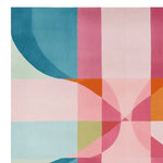 A vibrant area rug featuring an abstract design with geometric patterns in shades of blue, pink, orange, and green. This hand tufted wool rug is ideal as a square area rug for living rooms, particularly in 8x10 dimensions, adding a colorful touch to any space.