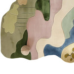 A beautifully designed area rug with an abstract pattern in pastel colors, perfect for a wool rug in a modern living room. This large living room rug showcases a blend of green, pink, beige, and blue tones, adding a touch of elegance and style.