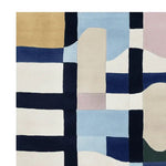 A contemporary hand-tufted wool area rug featuring an abstract geometric pattern. The design includes bold blocks of color in shades of blue, beige, and cream, perfect for a large living room. This stylish area rug adds a modern touch to any space.