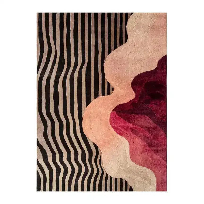 The Pattern Play Hand Tufted Rug is a stunning area rug featuring a contemporary design. It showcases bold black and beige stripes on one side, transitioning into abstract waves of pink, red, and burgundy on the other. This wool rug is perfect for adding a modern touch to bedroom spaces, serving as an elegant and stylish option for bedroom area rugs.