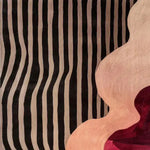Contemporary area rug featuring a striking abstract design with wavy black and beige stripes on one side, blending into a swirling pattern of pink and red hues. Ideal for adding a modern touch to bedroom decor, this hand-tufted wool rug offers both style and comfort, making it a perfect choice for bedroom area rugs.