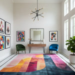 Modern living room with colorful rug, chairs, and wall art.