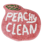 A charming peach-shaped runner rug featuring the words 'Peachy Clean' in bold white letters against a soft pink background. Ideal for adding a playful touch to kitchens, hallways, or bathrooms, this cotton rug combines style with practicality.