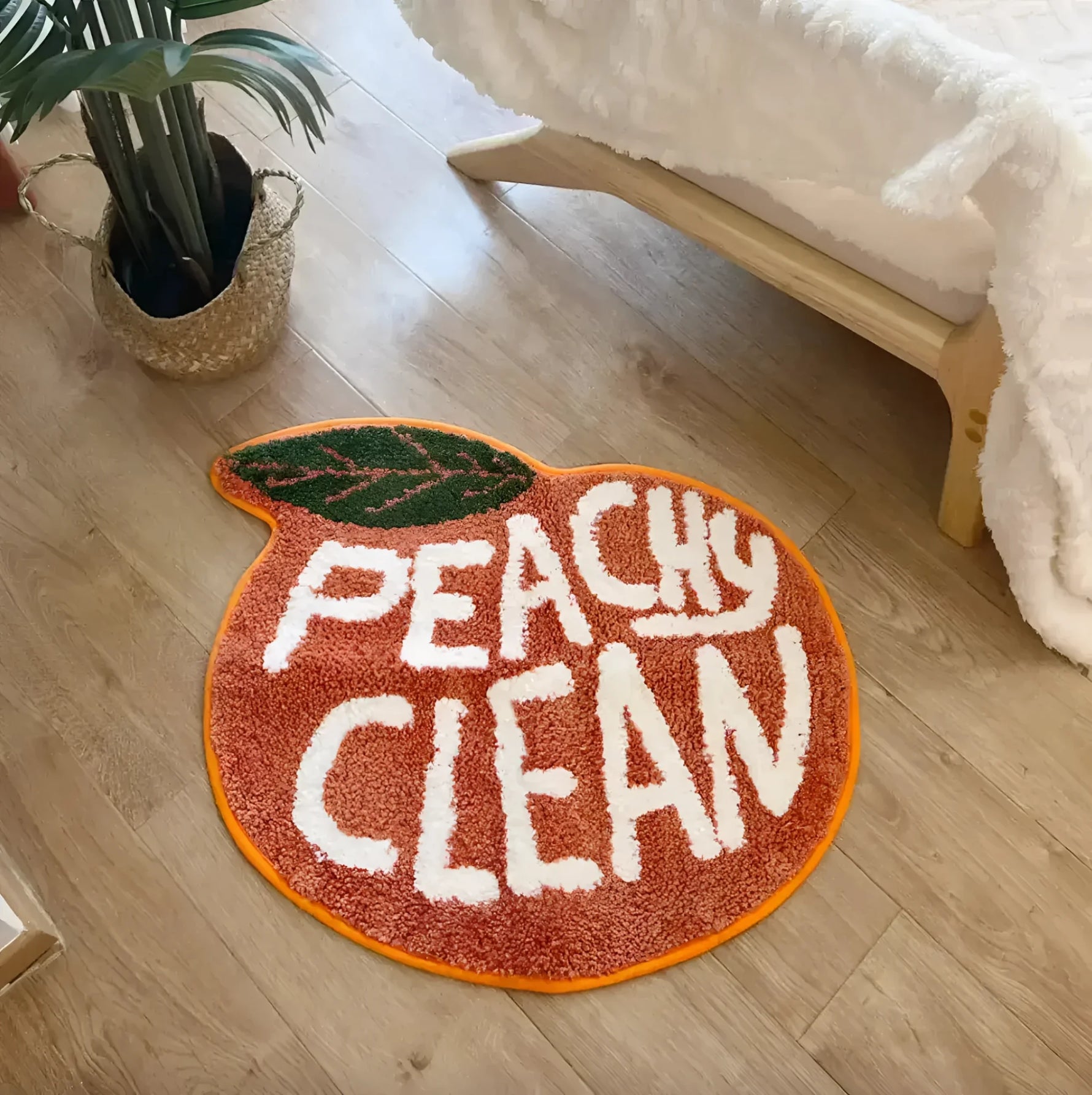 A vibrant Peachy Clean bathmat shaped like a peach, adding a playful touch to any room. This runner rug is perfect for kitchens, hallways, or bathrooms, blending style with functionality. Made from soft cotton, it brings warmth and comfort to your space.
