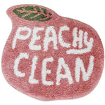 The Peachy Clean Bathmat, a charming runner rug shaped like a peach with a green leaf accent, features bold white text that reads 'Peachy Clean' on a plush pink cotton surface. Perfect for adding a playful touch to kitchen rugs, hallway runner rugs, or as a bathroom runner rug.