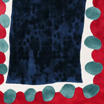 A vibrant pebbled frame hand tufted area rug featuring a bold abstract design. The contemporary rug showcases a deep blue center, bordered by a playful pattern of teal and red shapes on a white background. Perfect for adding a touch of modern style to any living room, this wool rug is ideal as an 8x10 living room rug.