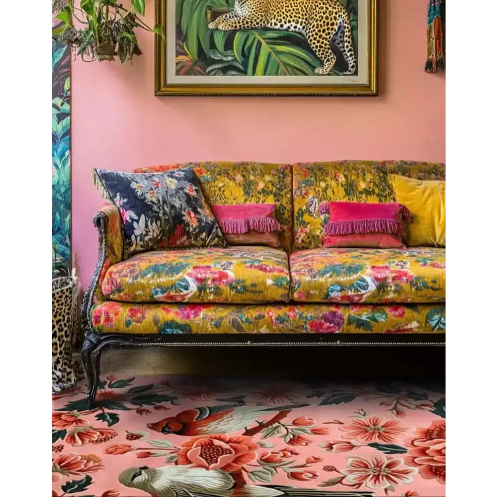 Stylish living room featuring a Peony Meadow Hand Tufted Area Rug with vibrant floral designs. The wool rug complements the colorful sofa and artwork, creating a lively and inviting space. Ideal for living room rugs 8x10.