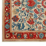Close-up view of the Persian Bloom Hand Tufted Wool Rug, showcasing its intricate floral design in vibrant reds, blues, and creams. This area rug is perfect for adding elegance to large living spaces, especially as a living room rug 8x10, providing a luxurious touch with its wool texture.