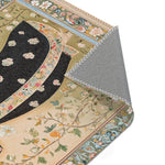 Persian Elegance Floral Black Robe Art Rugs corner folded back revealing grey non-slip backing with black floral figure and botanical pattern visible