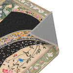 Folded corner of the Persian Hand-Painted Floral Calligraphy Rug exposing grey backing, cream body with dark swirling robe design visible