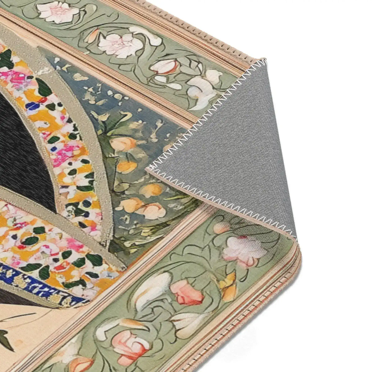 Angled corner fold of the Persian Hand-Painted Floral Calligraphy Rug showing green-sage scrollwork border and grey textured backing