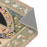 Angled corner fold of the Persian Hand-Painted Floral Calligraphy Rug showing green-sage scrollwork border and grey textured backing
