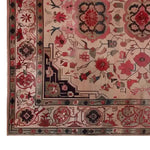 Close-up of a Persian Opulence hand-tufted wool rug featuring intricate floral patterns in red and pink hues, perfect as an area rug for living rooms.