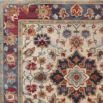 Close-up of a Persian Palette Hand Tufted Rug, showcasing a vibrant floral design. This square area rug features intricate patterns in rich red, blue, and beige tones, ideal for adding a vintage touch to living room decor. Perfect wool rug for those seeking Persian rugs with a classic elegance.