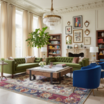 Living room with green sofa, blue chairs, and decorative vintage red rug.