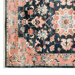 A beautifully detailed Persian Serenade hand-tufted wool rug showcasing intricate floral patterns in soft pink and deep blue hues. This luxurious area rug is perfect for adding elegance to any living room, embodying the classic charm of Persian rugs.