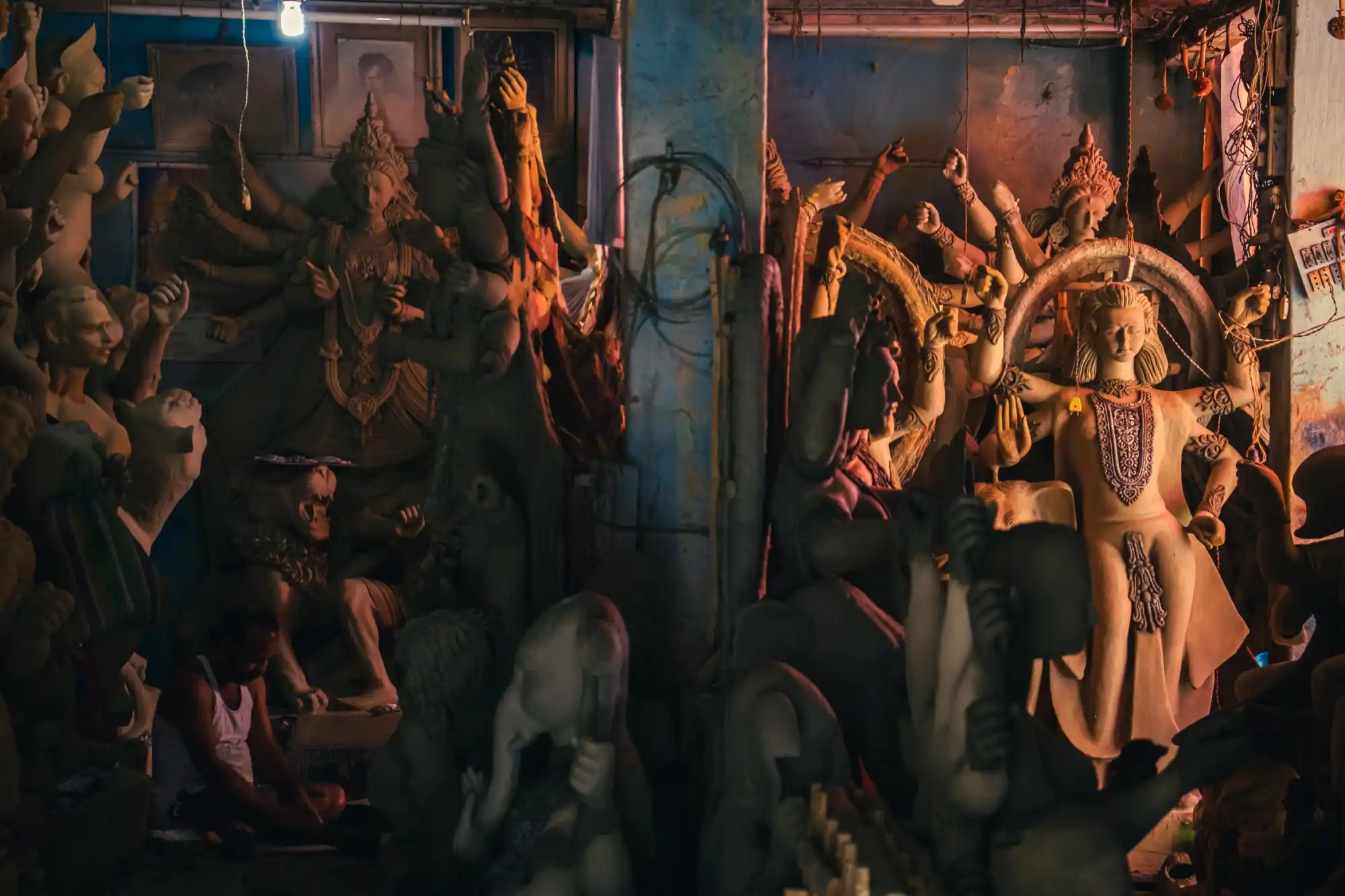 Statues in a dimly lit room, possibly a temple or shrine.