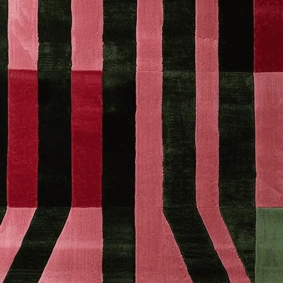 This image showcases a contemporary area rug with bold, parallel stripes in shades of red, pink, and black. Perfect for adding a modern touch to living room spaces, this hand-tufted wool rug is a stylish choice for those seeking living room area rugs. Its 8x10 size makes it ideal for larger spaces, blending both functionality and artistic design.