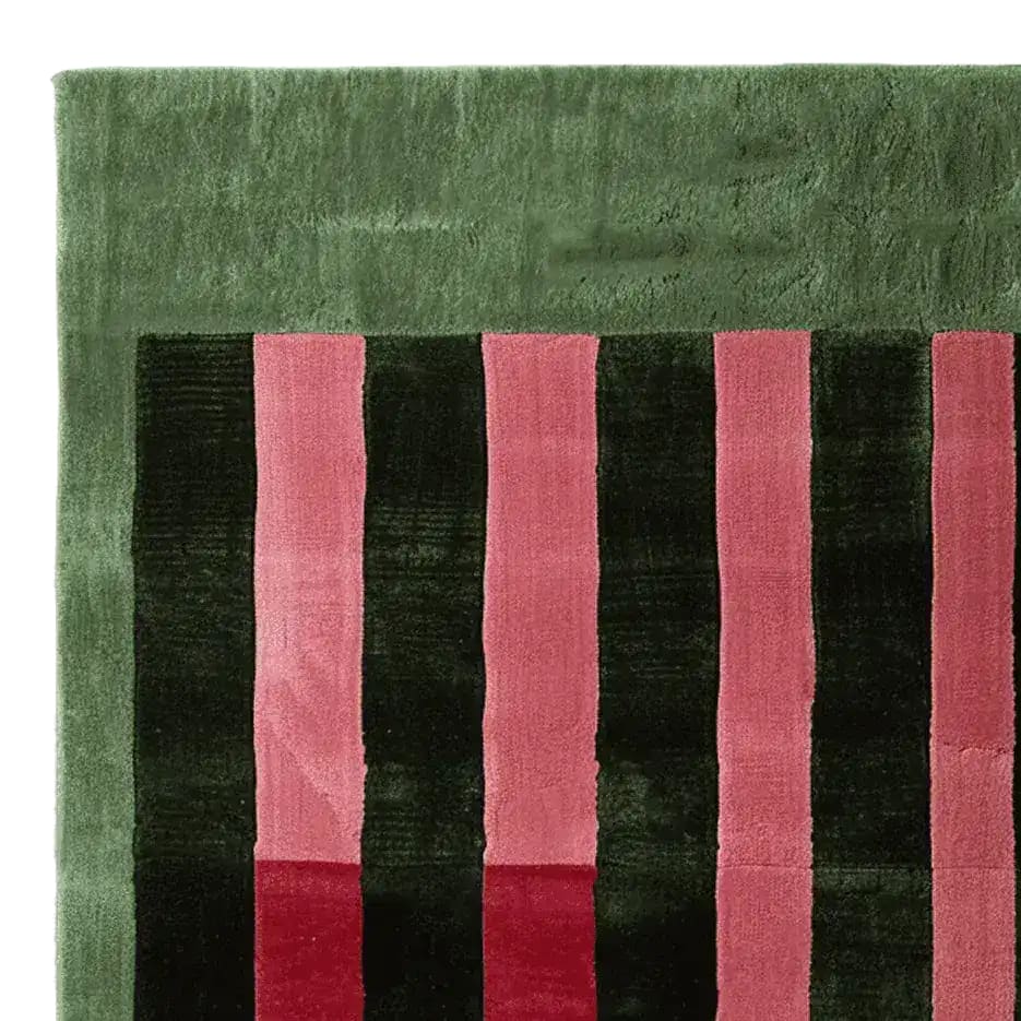 A close-up view of the Perspective Line Fall Hand Tufted Area Rug showcasing its contemporary design with bold green and pink stripes. Perfect for adding a modern touch to living room area rugs, this 8x10 wool rug brings a vibrant aesthetic to any space.