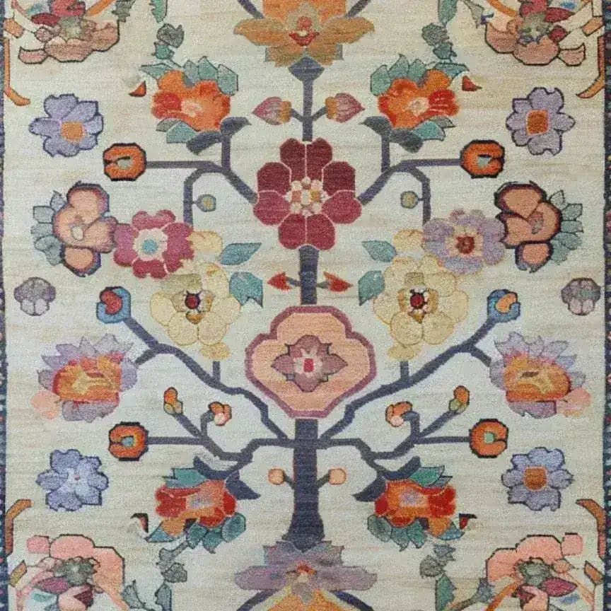 A beautifully detailed Petal Cascade Hand Knotted Area Rug featuring an intricate floral pattern. This vintage-inspired Persian rug is ideal for large living rooms and measures 8x10. The vibrant colors and classic design bring elegance and charm, making it a perfect choice for those seeking a floral touch in their home decor.