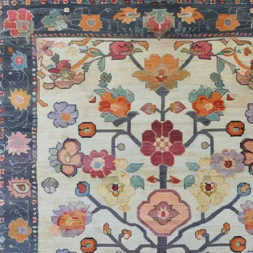 Close-up view of the Petal Cascade Hand Knotted Area Rug featuring a vibrant floral design. This vintage rug showcases intricate patterns with multicolored flowers on a soft, neutral background, ideal for large living rooms. Perfect as a Persian-style living room rug, this 8x10 floral rug adds elegance and charm.
