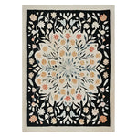 Luxurious room with dark wood cabinetry, a chandelier, and a decorative rug.