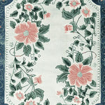 Beautiful Petal Crest Bloom Hand Tufted Area Rug featuring an elegant floral design with pink flowers and green leaves on a soft background, perfect for adding a touch of nature to living room area rugs. This wool rug is an ideal choice for those seeking exquisite rugs for living room decor.