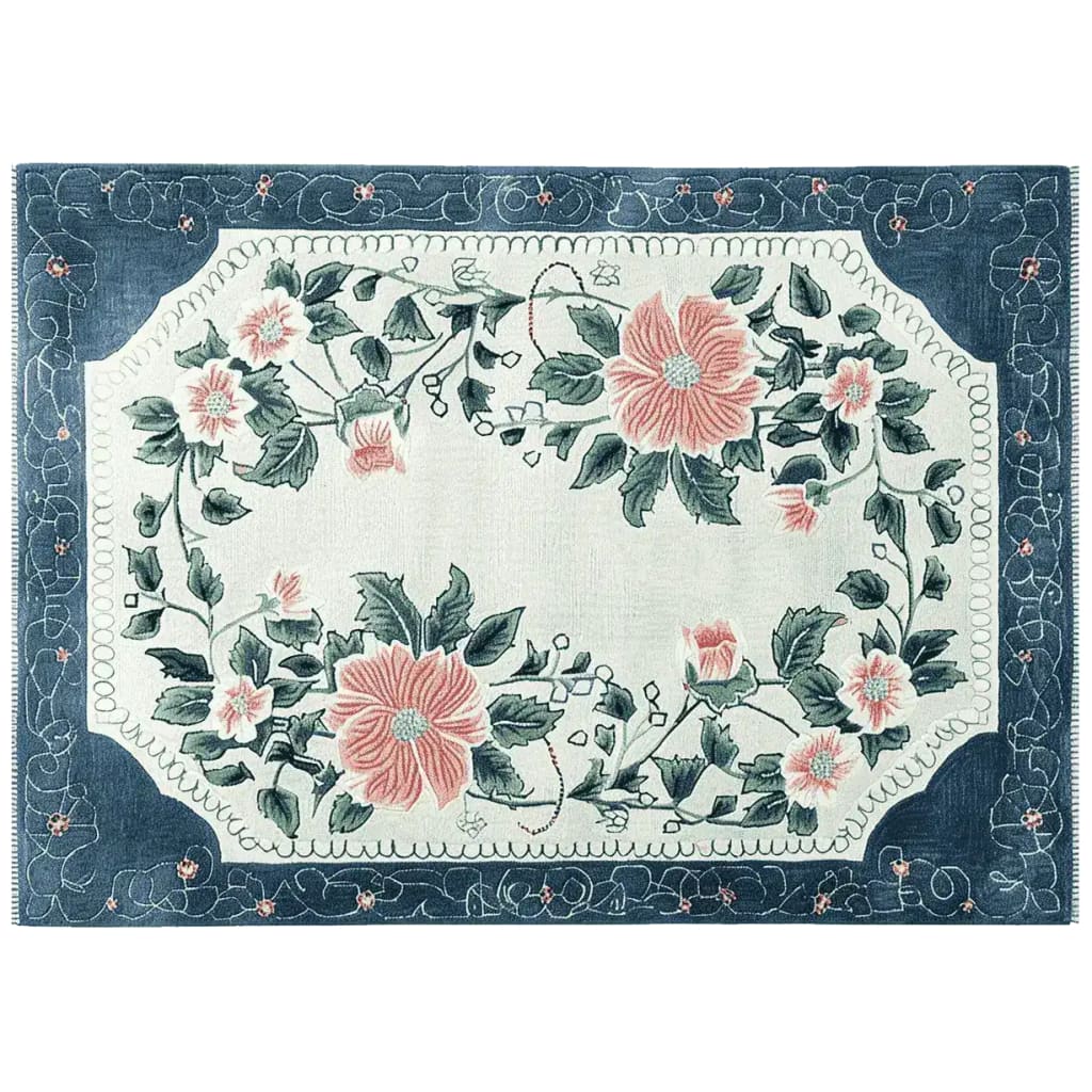 This stunning area rug features a vibrant floral design with large pink blooms and lush green leaves, set against a soft background. The intricate pattern is framed by a rich blue border, making it a perfect addition to any living room looking for a touch of elegance. Made from high-quality wool, this hand-tufted floral rug combines style and durability, ideal for those seeking beautiful rugs for living room spaces.