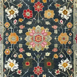 This is a close-up view of the Petal Illusion Hand Knotted Area Rug, featuring a vibrant floral pattern with intricate designs in hues of red, pink, orange, and white against a dark background. Perfect for those seeking living room rugs 8x10, this vintage rug adds a touch of elegance reminiscent of Persian rugs, making it an ideal choice for any rugs for living room setting.