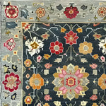 Close-up of the Petal Illusion Hand Knotted Area Rug showcasing a vintage Persian-inspired floral design. The intricate pattern features vibrant red, orange, and pink flowers on a dark background, perfect for adding elegance to living room rugs 8x10.