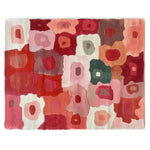 Vibrant abstract design of the Petal Mosaic Hand Tufted Wool Rug, showcasing a colorful blend of pink, red, and orange hues. This large area rug is perfect for adding warmth and style to a living room.