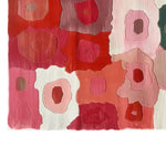 A vibrant Petal Mosaic Hand Tufted Wool Rug showcasing an abstract design with bold, overlapping petal shapes in shades of red, pink, and orange. Perfect as a large area rug for living rooms, this wool rug adds a touch of artistic flair and warmth to any space.