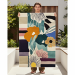 Person holding a colorful abstract rug outdoors