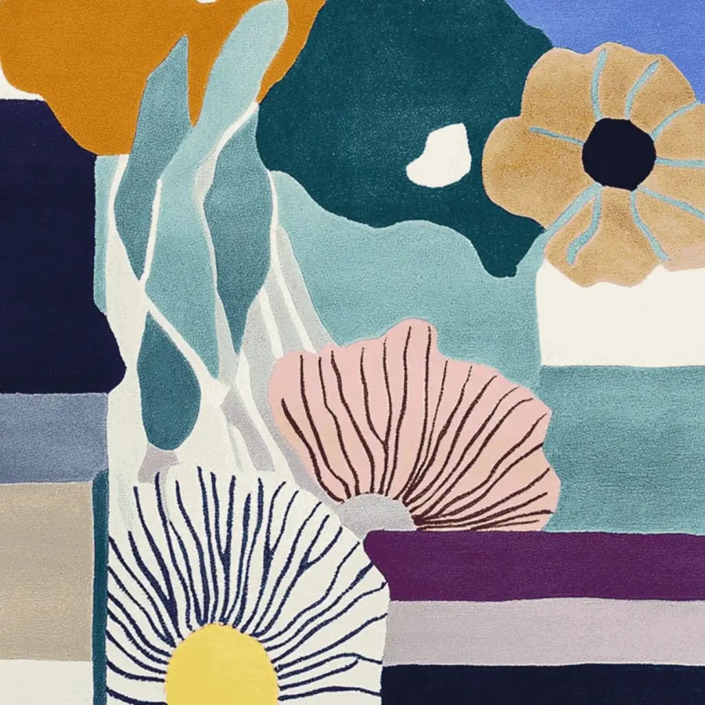 A vibrant hand-tufted area rug featuring an abstract floral design with bold colors like blue, pink, and mustard. This contemporary wool rug, perfect for large living rooms, measures 8x10, offering a stylish and artistic touch to any space.