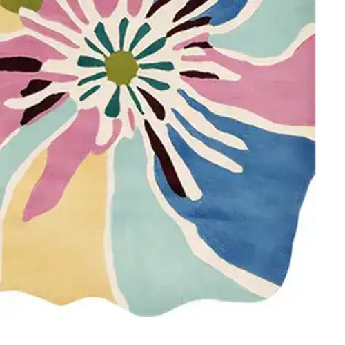 Vibrant close-up of the Petal Power Pop Hand Tufted Area Rug, showcasing a contemporary floral design with bold colors like pink, blue, yellow, and green. Perfect for adding a splash of color to living room area rugs, this wool rug combines modern style with comfort.