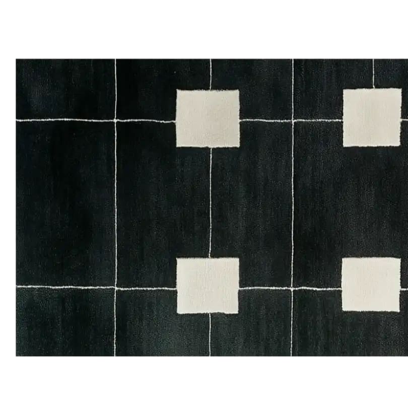A contemporary hand tufted wool runner rug featuring a geometric pattern with white squares on a dark background. Ideal for use as a hallway runner rug, kitchen rug, or bathroom runner rug, this elegant and modern wool rug adds a touch of sophistication to any space.