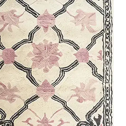 Close-up view of the Petal Veil Mosaic Hand Tufted Area Rug, showcasing intricate floral patterns in soft pinks and elegant black outlines. Perfect for adding a vintage touch to your dining room or as a stylish 8x10 wool rug for the living room.