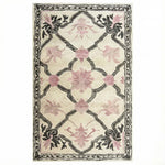 Elegant Petal Veil Mosaic Hand Tufted Area Rug, perfect for adding a vintage touch to your living room or dining room. The design features delicate pink floral patterns with intricate black detailing on a cream background, ideal for living room rugs 8x10 or as a wool rug centerpiece.