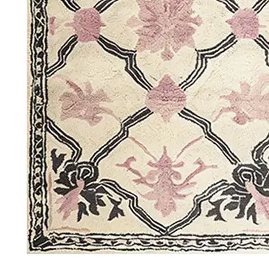 A close-up of the Petal Veil Mosaic Hand Tufted Rug, showcasing its vintage floral design in soft pink and black tones. This elegant wool area rug is perfect for adding a touch of sophistication to a dining room or as an 8x10 centerpiece in a living room. The intricate patterns make it a standout choice for those seeking stylish living room area rugs.