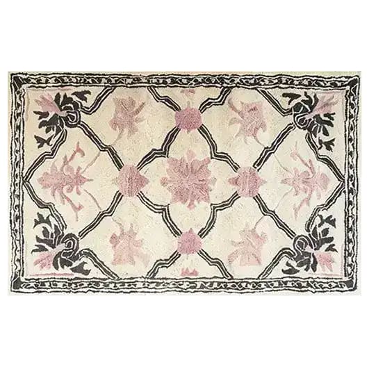 This Petal Veil Mosaic Hand Tufted Rug showcases an elegant vintage design with soft pink floral patterns and a black border, perfect for adding a touch of sophistication to your dining room or living room. Ideal for use as an 8x10 living room area rug, this wool rug combines traditional charm with modern aesthetics.