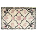 This Petal Veil Mosaic Hand Tufted Rug showcases an elegant vintage design with soft pink floral patterns and a black border, perfect for adding a touch of sophistication to your dining room or living room. Ideal for use as an 8x10 living room area rug, this wool rug combines traditional charm with modern aesthetics.