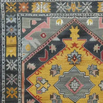 Close-up of the 'Petals in Motion' hand-knotted area rug, showcasing its intricate vintage design with vibrant colors and Persian influences. Perfect for adding a touch of elegance to any living room space.