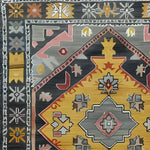 Close-up of the 'Petals in Motion' hand-knotted area rug, showcasing its intricate vintage design with vibrant colors and Persian influences. Perfect for adding a touch of elegance to any living room space.