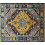 Top view of a vibrant, hand-knotted area rug showcasing a vintage Persian design. The rug features a striking geometric pattern with bold colors, perfect for enhancing living room decor.