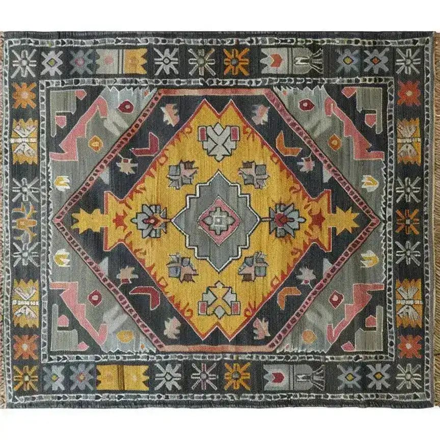 Top view of a vibrant, hand-knotted area rug showcasing a vintage Persian design. The rug features a striking geometric pattern with bold colors, perfect for enhancing living room decor.